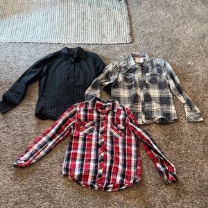 Three men’s button-down, long sleeve shirts